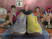 Front view of mismatched Nike sneakers with yellow and lavender-gray mesh uppers, tonal laces, and contrasting outsoles.