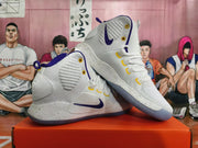 Angled view of white Nike Hyperdunk high-tops showing purple and yellow accents and speckled midsoles.