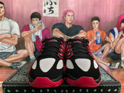 Front view of black, white, and red Nike basketball sneakers with black laces and white upper panels.
