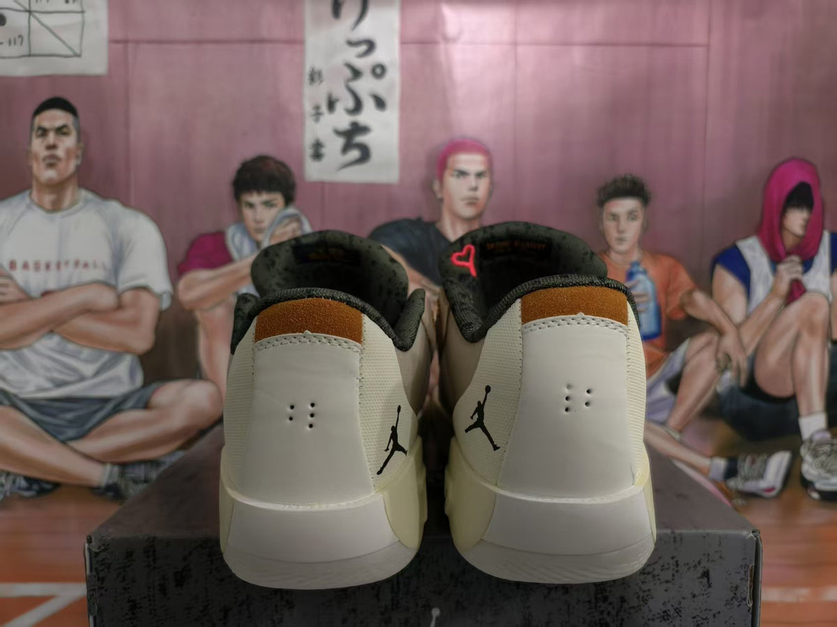 Rear view of beige and cream basketball sneakers showing black heel logos, padded collars, and contrasting tongue details.