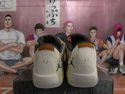 Rear view of beige and cream basketball sneakers showing black heel logos, padded collars, and contrasting tongue details.