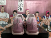 Rear view of the pink Nike sneakers showing padded collars, heel panels, and contrasting pale soles.