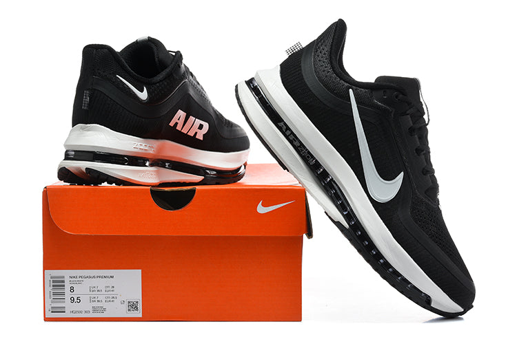 Black and white Nike Pegasus Premium shoes displayed with an orange box; its label shows sizes 8 and 9.5.