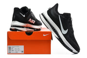 Black and white Nike Pegasus Premium shoes displayed with an orange box; its label shows sizes 8 and 9.5.