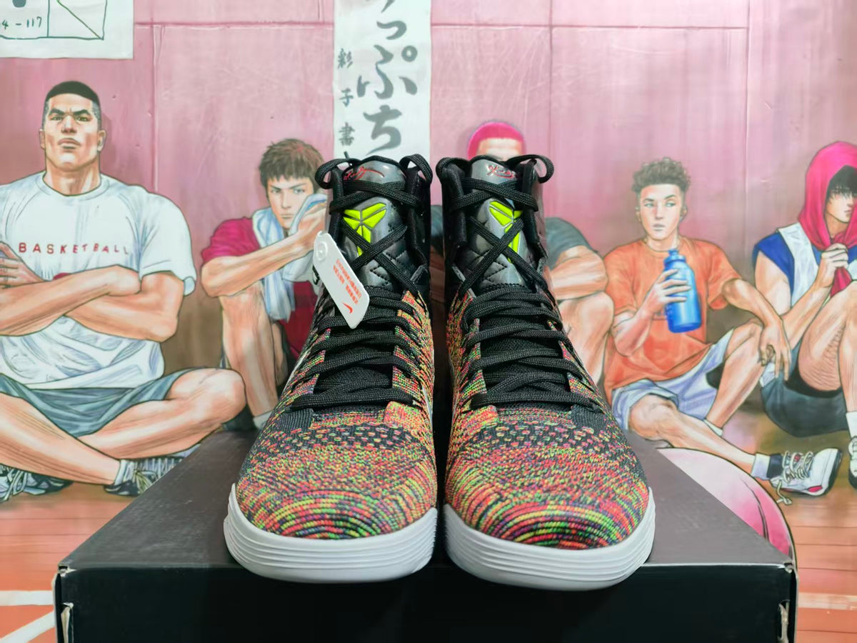 Front view of black high-top basketball sneakers with multicolor woven-texture toes, neon yellow tongue details, and white outsoles on a black box.