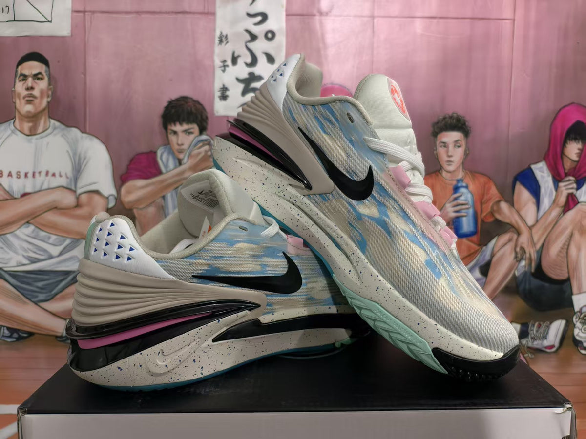 Pair of light blue camouflage-style basketball sneakers shown from a side angle, with black Swoosh logos, pink accents, and speckled midsoles.