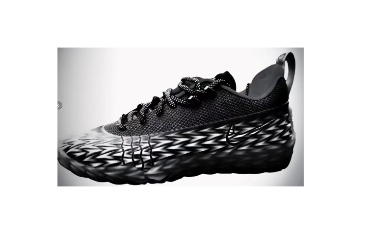Black low-top basketball sneaker with patterned midsole and side Swoosh