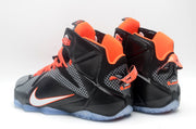 Rear and side view of black and grey high-top basketball sneakers with bright orange collar lining and accents.