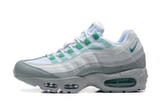 Side view of white, grey, and green Nike Air Max 95 TT sneakers