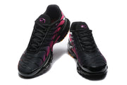 Front view of black and pink Nike Air Max Plus sneakers