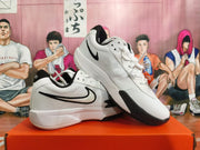 Angled view of a pair of white Nike basketball shoes with black accents