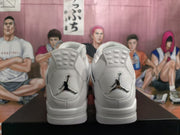 Rear view of white sneakers showing heel padding and black Jumpman branding.