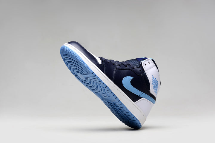 Jordan 1 Retro sneaker showing the navy upper, light blue outsole, and white heel panels