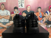 Rear view of a pair of black Jordan sneakers showing glossy heel panels, pull tabs, and Jumpman logos.