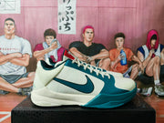 Side view showing the cream upper, teal Swoosh, perforated panels, padded collar and Zoom marking near the sole.
