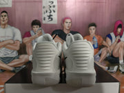 Rear view of white Nike sneakers showing the ribbed heel sections and outsole edges.