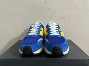 Front view of blue and yellow New Balance U370 sneakers with white laces