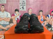 Front view of black lace-up Nike running shoes