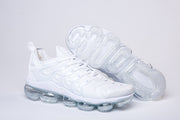 White Nike TN-2 sneaker beside its outsole view, showing the tread and clear sole sections.