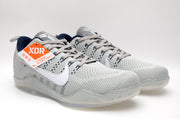 Pair of gray Nike Kobe 11 low-top shoes with white Swooshes and navy accents