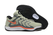 Gray and light-colored Nike KD 17 basketball shoes with orange accents and a black outsole.