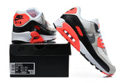 Nike Air Max 90 sneakers displayed with a shoe box; the visible box label shows a sample size.