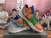 Angled view of the pair showing the orange, green and blue color combination, layered overlays and textured outsole.