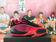 Side profile showing the patterned red-and-black upper, Jumpman logo, and red midsole accents.
