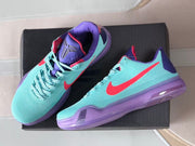 Top and side view of the pair showing the aqua uppers, purple tongues, coral accents, and lace fastening.