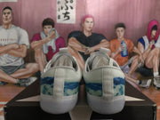 Rear view of the pair showing the blue patterned heel panels, pull tabs, and white soles.