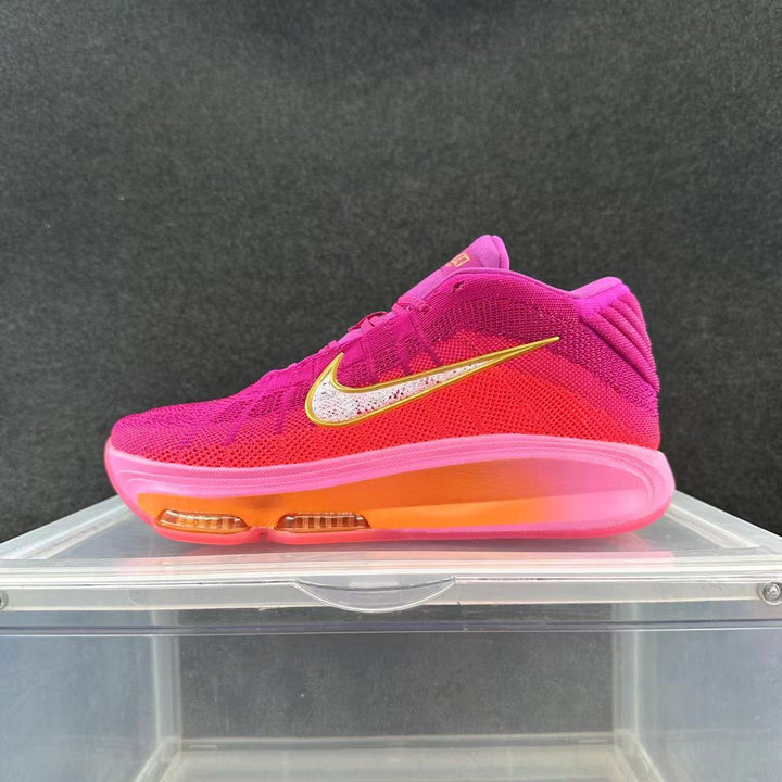 Side view of a pink and purple Nike basketball sneaker with a contrasting swoosh and visible cushioning units in the sole.