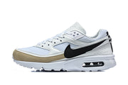 Side view of white Nike Air Max BW sneakers with black Swoosh and beige toe overlay