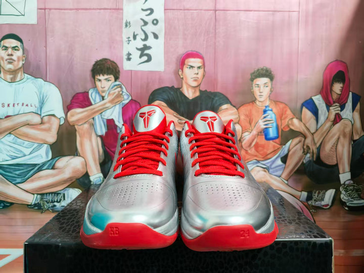 Front view of silver and red Nike basketball sneakers with red laces and perforated toe panels.