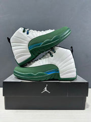 White and green sneaker pair shown from the side with green textured overlays and blue-toned midsole accents.