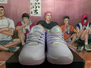 Front view of lavender and white basketball sneakers with matching laces, mesh-like toe panels, and layered purple accents.