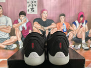 Rear view of the black Jordan sneakers showing padded heels, red branding details and white midsoles.