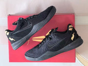 Two angled views of black Nike Kobe 8 shoes with gold-tone accents