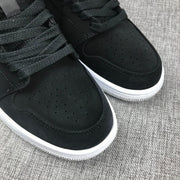 Close-up of the black perforated toe box and black woven laces.