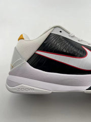 Close-up of the shoe side showing the black panel, white Swoosh with red trim, and pale midsole