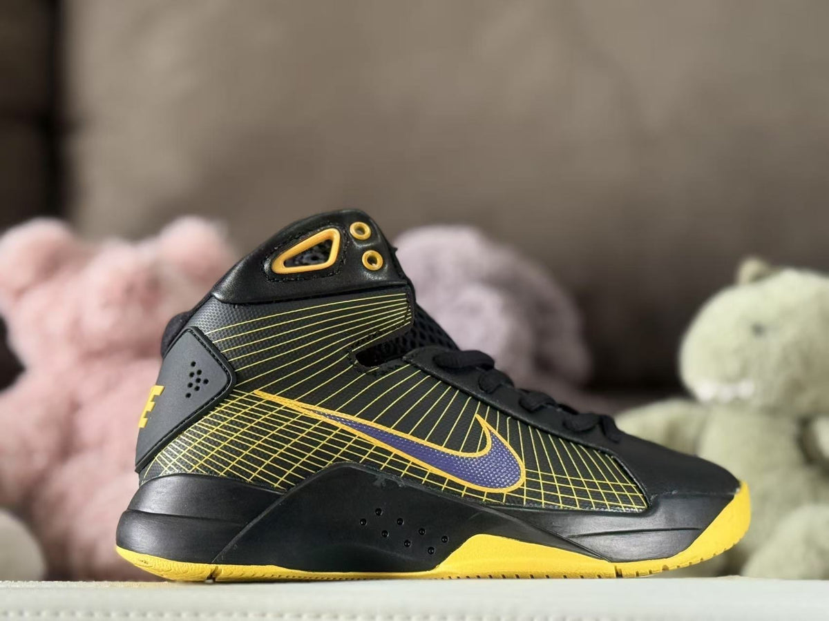 Side view of black and yellow Nike Kobe HD2008 high-top sneakers with a patterned upper and purple Swoosh.
