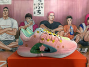 Side view of the pink sneaker showing its patterned panels, Swoosh, and hanging charm.