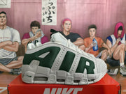 Side profile of one white and dark green Nike sneaker showing layered overlays and a visible air-cushion window.