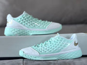 Side view of a mint and white Nike Kobe 3 shoe with gold logo