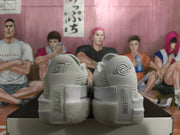 Rear view of white Nike basketball shoes with contrasting heel logos and sculpted soles.
