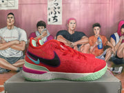 Side view of a red Nike basketball shoe with a black and blue-green swoosh, mint-green heel detail, and speckled midsole.