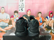 Rear view of black Nike basketball shoes with textured heel panels.