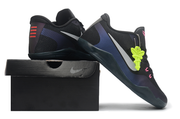 Black and purple Kobe 11 shoes posed on a black shoe box