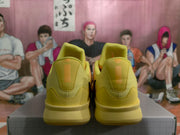 Rear view showing the yellow heel panels and padded collars of the sneakers.