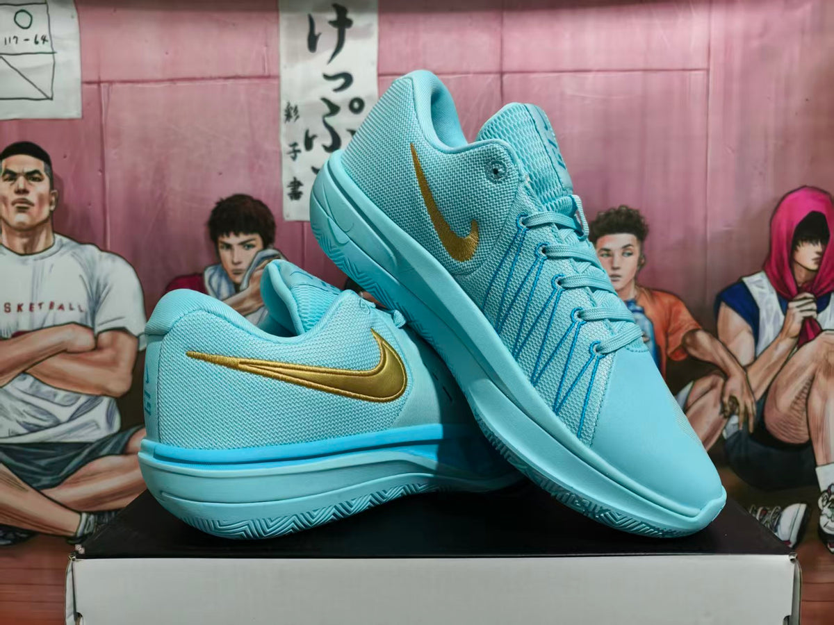 Pair of blue Nike basketball shoes with gold-tone Swoosh details, shown from the side and at an angle.
