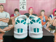 Rear view of the pair showing teal-and-white heel panels and white midsoles.